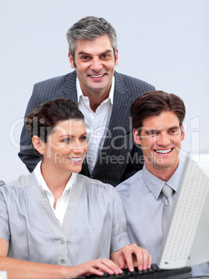 Enthusiastic businessteam working at a computer