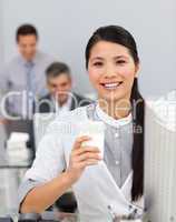 Asian woman drinking coffee in the office