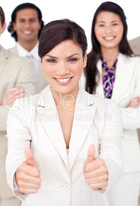 Attractive businesswoman and her team with thumbs up