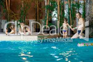 Family in swimming-pool