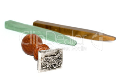 Stamp and sealing wax on white background