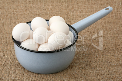 Metal ladle with eggs