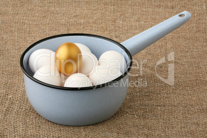 Gold egg among white