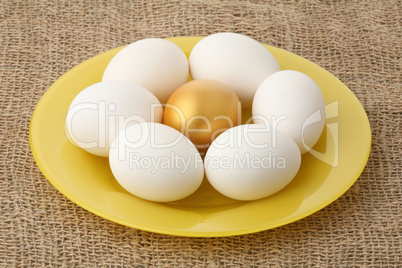 Gold egg among white
