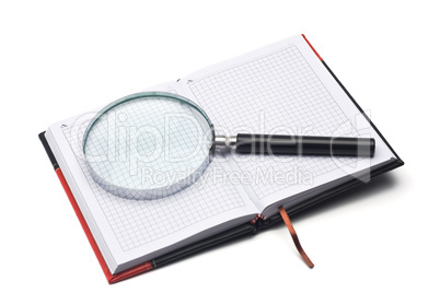 notepad and hand magnifier