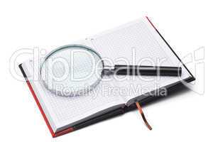 notepad and hand magnifier