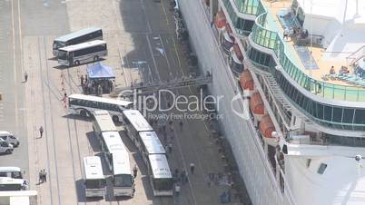 Passengers disembark from a cruise liner