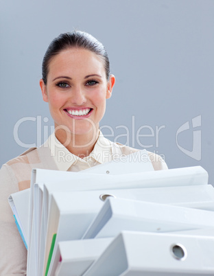 Charming businesswoman carrying folders