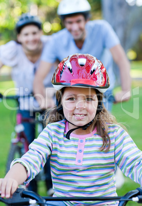 Cute little girl riding a bike