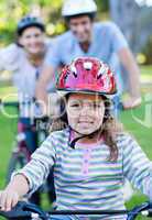 Cute little girl riding a bike