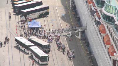 Passengers disembark from a cruise liner