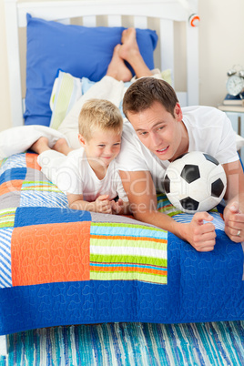 Handsome father and his son playing with a soccer ball