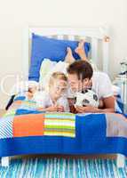 Attractive father and his son playing with a soccer ball