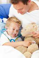 Positive father and his sick son playing with a stethoscope