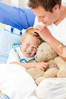 Smiling father and his sick son playing with a stethoscope