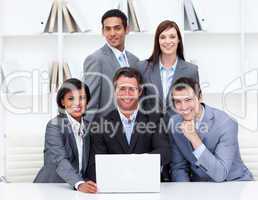 Successful business team looking at a laptop