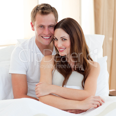 Intimate lovers embracing lying in bed