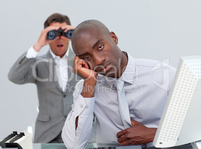 Ethnic businessman getting bored and his manager looking through