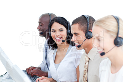 Brunette woman and her team working in a call center