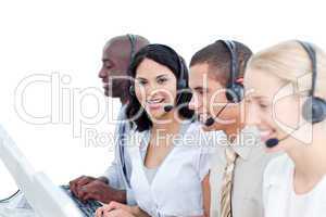 Brunette woman and her team working in a call center