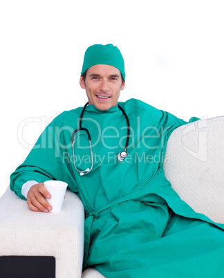 Charismatic surgeon drinking coffee in the staff room