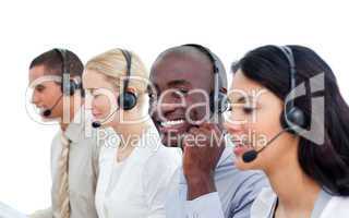 Attractive man and his team working in a call center