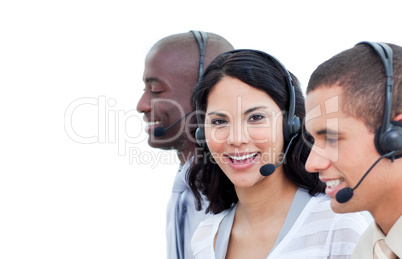 Portrait of a brunette woman and her team working in a call cent