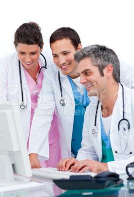 Enthusiastic medical team working at a computer Enthusiastic medical team working at a computer