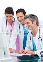 Enthusiastic medical team working at a computer