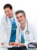 Two male doctors working at a computer