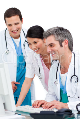 Joyful medical team working at a computer