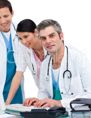 Cheerful medical team working at a computer