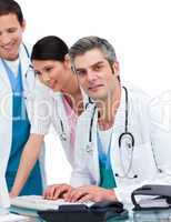 Cheerful medical team working at a computer