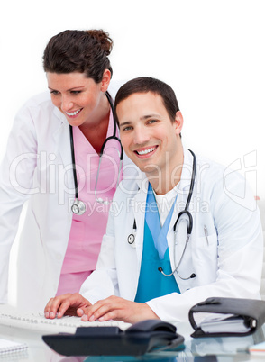 Two jolly doctors working at a computer