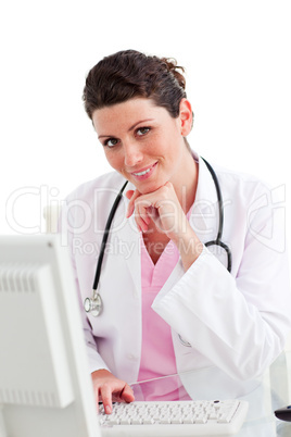 Smiling female doctor working at a computer