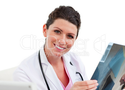 Young female doctor looking at X-ray