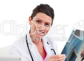 Young female doctor looking at X-ray