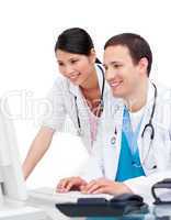 Two happy doctors working at a computer