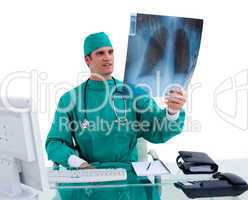 Charming surgeon looking at X-ray