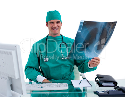 Young surgeon looking at X-ray