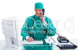 Enthusiastic surgeon on phone working at a computer