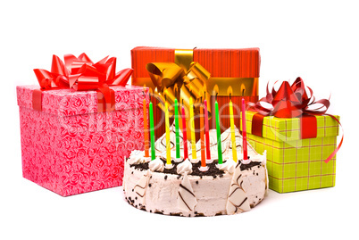 Pie with eleven candles and gifts in boxes on a white background
