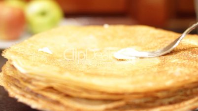 female hand oils pancakes.