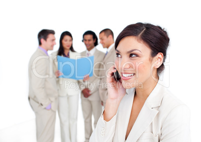 Portrait of a laughing businesswoman on phone with her team