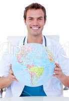 Portrait of a smiling male doctor holding a terrestrial globe