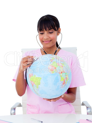 Portrait of a female doctor examining a terrestrial globe