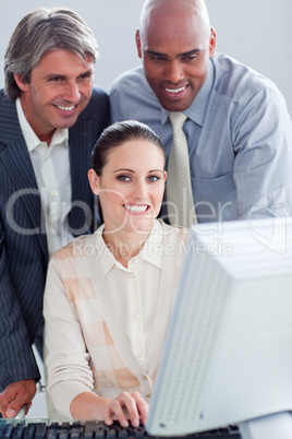 Portrait of a businesswoman and her colleagues working at a comp