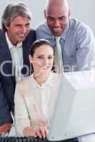 Portrait of a businesswoman and her colleagues working at a comp