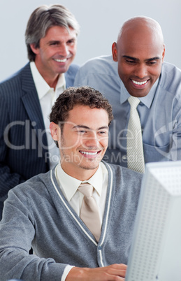 Smiling businessmen working at a computer