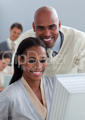 Portrait of two enthusiastic businesspeople working at a compute